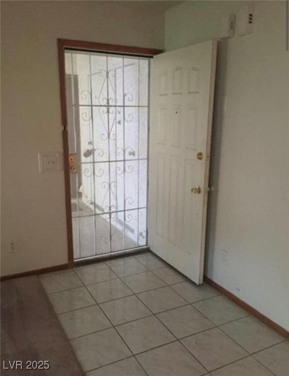 6671 W Tropicana Ave Unit 103, Las Vegas, NV 89103 - entrance foyer featuring baseboards and light tile patterned flooring