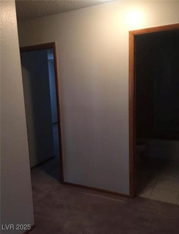 6671 W Tropicana Ave Unit 103, Las Vegas, NV 89103 - hallway featuring a textured ceiling