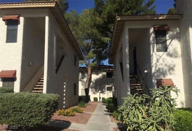 6671 W Tropicana Ave Unit 103, Las Vegas, NV 89103 - view of property exterior with stairway and stucco siding