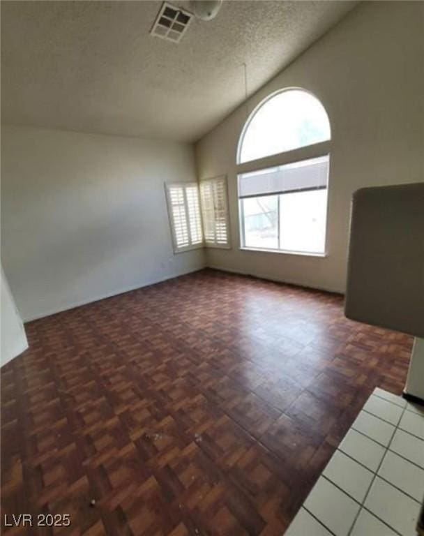 9820 Cross Creek Way, Las Vegas, NV 89117 - spare room with vaulted ceiling and a textured ceiling