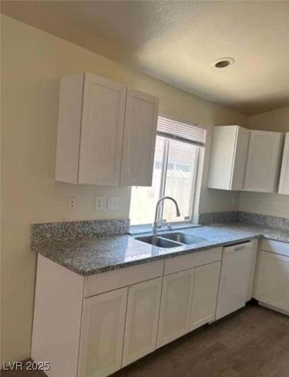 9820 Cross Creek Way, Las Vegas, NV 89117 - kitchen featuring white cabinetry, dishwasher, dark wood finished floors, and light stone counters