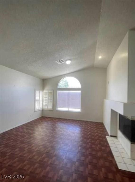 9820 Cross Creek Way, Las Vegas, NV 89117 - unfurnished living room with vaulted ceiling and a textured ceiling