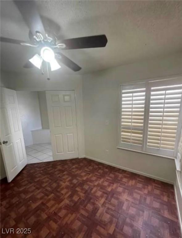 9820 Cross Creek Way, Las Vegas, NV 89117 - unfurnished bedroom with a textured ceiling and a ceiling fan