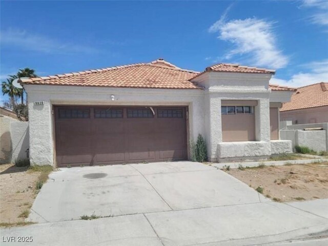 9820 Cross Creek Way, Las Vegas, NV 89117 - mediterranean / spanish-style house featuring a tiled roof, a garage, concrete driveway, and stucco siding
