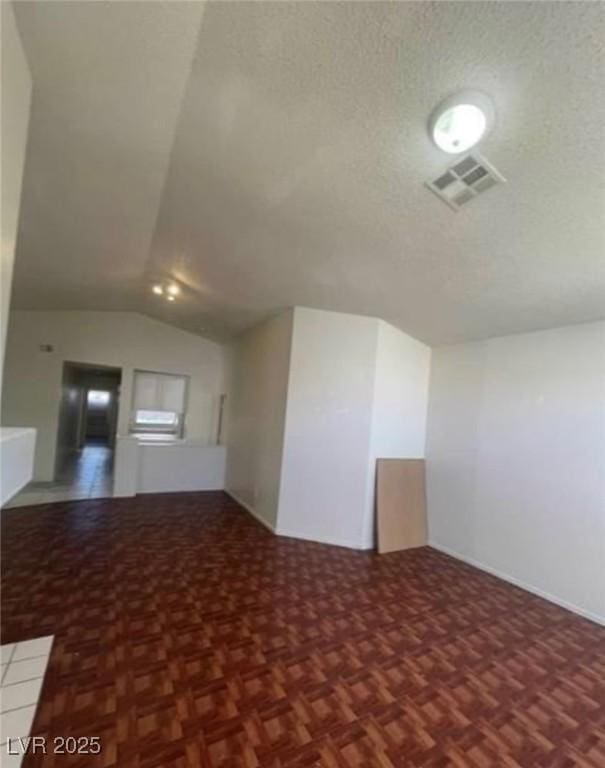 9820 Cross Creek Way, Las Vegas, NV 89117 - unfurnished living room featuring lofted ceiling and a textured ceiling
