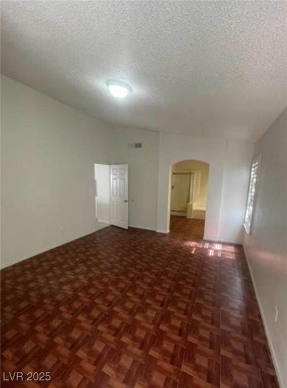 9820 Cross Creek Way, Las Vegas, NV 89117 - spare room with a textured ceiling and arched walkways