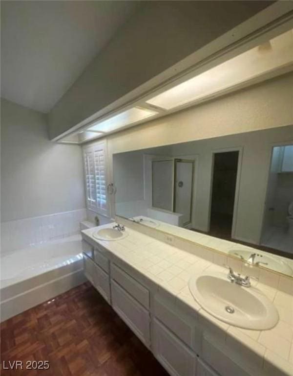 9820 Cross Creek Way, Las Vegas, NV 89117 - bathroom featuring a bath, double vanity, and lofted ceiling