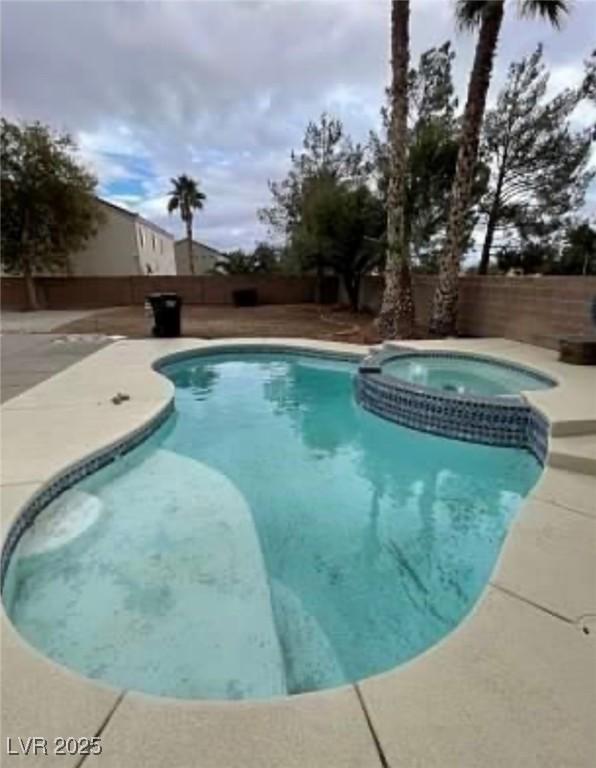 7879 Villa Pintura Ave, Las Vegas, NV 89131 - view of pool with a fenced backyard, a pool with connected hot tub, and a patio area