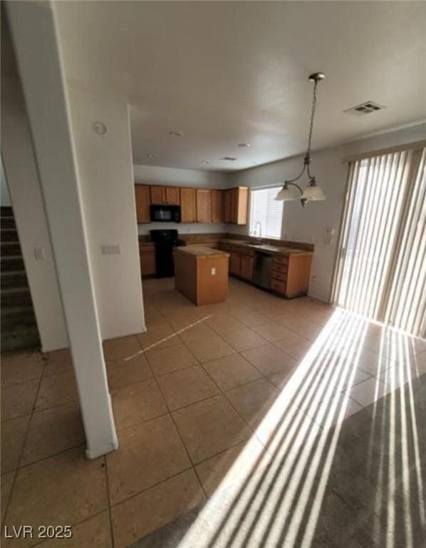 7879 Villa Pintura Ave, Las Vegas, NV 89131 - kitchen with black microwave, dishwashing machine, a center island, light tile patterned floors, and stove