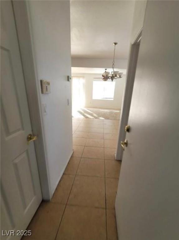 7879 Villa Pintura Ave, Las Vegas, NV 89131 - corridor featuring a chandelier and light tile patterned floors