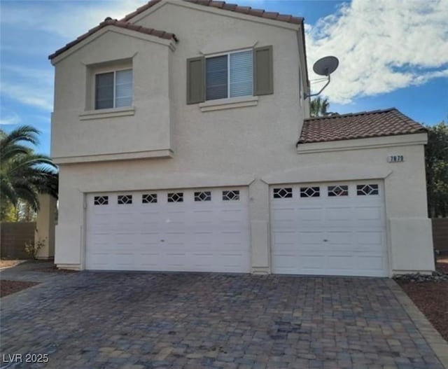 7879 Villa Pintura Ave, Las Vegas, NV 89131 - view of front of property with a tiled roof, stucco siding, a garage, and driveway