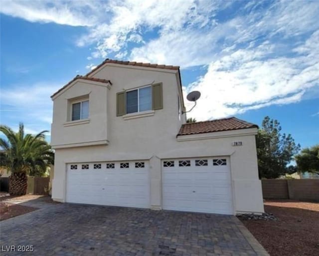 7879 Villa Pintura Ave, Las Vegas, NV 89131 - view of front of home featuring a tile roof, a garage, stucco siding, and driveway