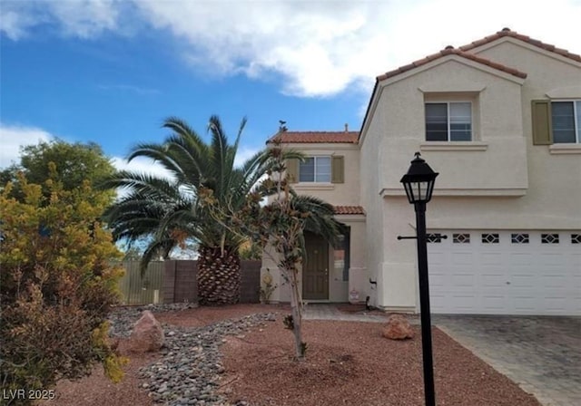 7879 Villa Pintura Ave, Las Vegas, NV 89131 - view of front facade with a garage, a tile roof, stucco siding, and driveway