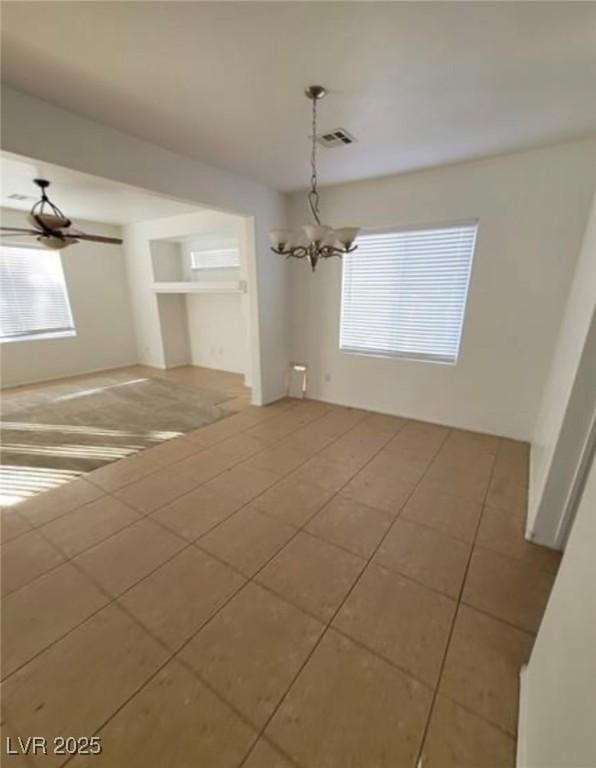 7879 Villa Pintura Ave, Las Vegas, NV 89131 - unfurnished room with a chandelier, healthy amount of natural light, and tile patterned flooring