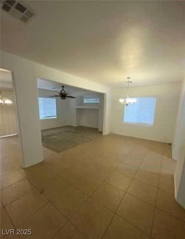 7879 Villa Pintura Ave, Las Vegas, NV 89131 - unfurnished living room featuring a chandelier and light tile patterned flooring