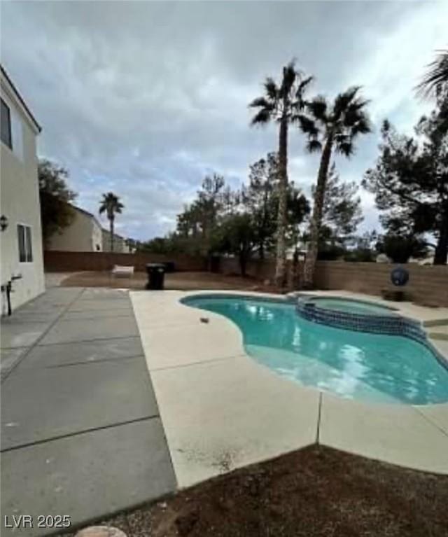 7879 Villa Pintura Ave, Las Vegas, NV 89131 - view of pool with a patio, a fenced backyard, and a pool with connected hot tub