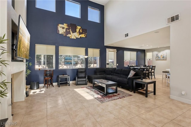 217 Turkey Creek Way, Henderson, NV 89074 - living room featuring a towering ceiling, tile patterned flooring, and a fireplace