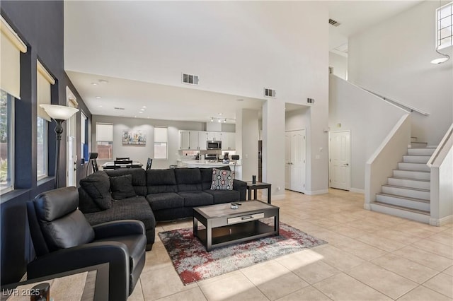 217 Turkey Creek Way, Henderson, NV 89074 - living area featuring stairway, plenty of natural light, light tile patterned flooring, and a towering ceiling