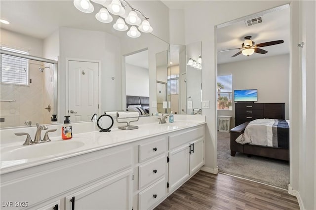 217 Turkey Creek Way, Henderson, NV 89074 - ensuite bathroom with double vanity, wood finished floors, a ceiling fan, and a shower stall