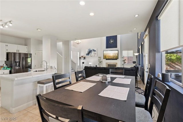 217 Turkey Creek Way, Henderson, NV 89074 - dining space with stairway, light tile patterned flooring, a tiled fireplace, and recessed lighting