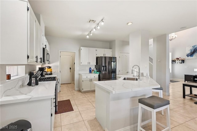 217 Turkey Creek Way, Henderson, NV 89074 - kitchen featuring appliances with stainless steel finishes, light tile patterned flooring, white cabinetry, and light stone countertops