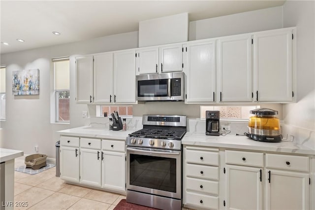 217 Turkey Creek Way, Henderson, NV 89074 - kitchen with appliances with stainless steel finishes, white cabinets, light tile patterned floors, and recessed lighting
