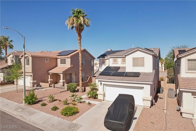 217 Turkey Creek Way, Henderson, NV 89074 - traditional home with a garage, solar panels, stucco siding, driveway, and a residential view