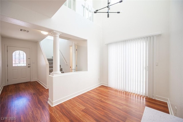 7388 Agonis St, Las Vegas, NV 89113 - foyer entrance with wood finished floors, a chandelier, stairway, and a high ceiling