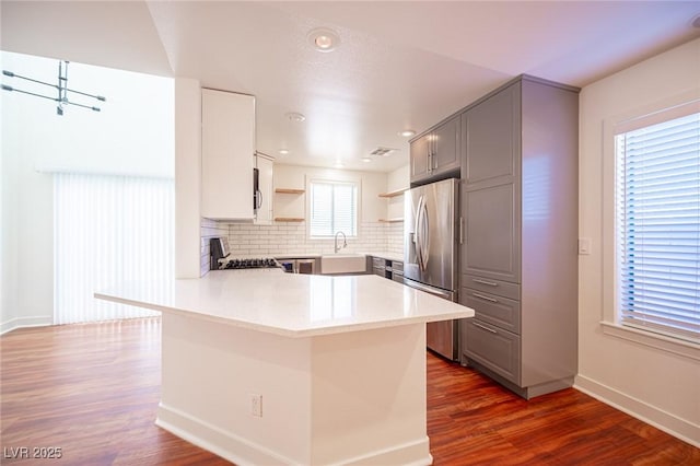 7388 Agonis St, Las Vegas, NV 89113 - kitchen with gray cabinetry, stainless steel fridge with ice dispenser, open shelves, dark wood-style floors, and recessed lighting