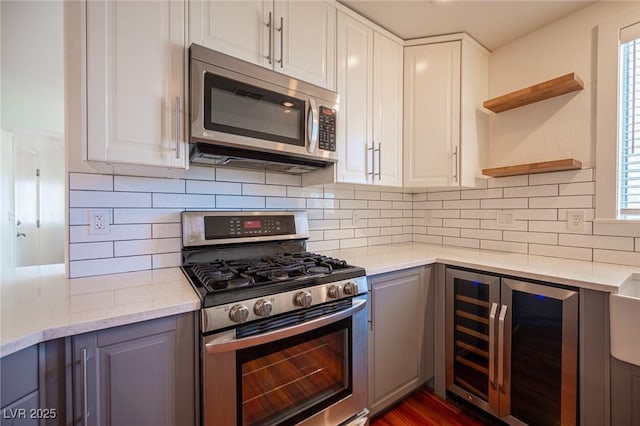 7388 Agonis St, Las Vegas, NV 89113 - kitchen featuring appliances with stainless steel finishes, wine cooler, open shelves, and white cabinets
