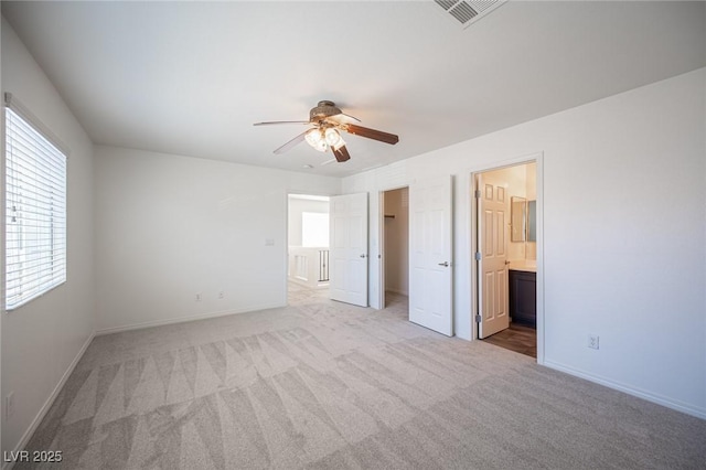 7388 Agonis St, Las Vegas, NV 89113 - unfurnished bedroom featuring light carpet, ensuite bathroom, a spacious closet, and a ceiling fan