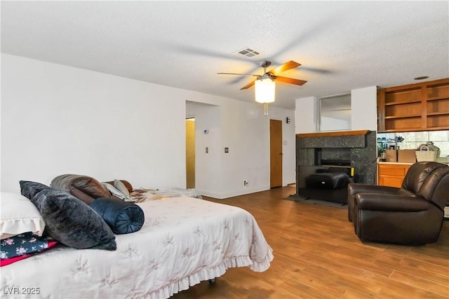 9109 Anchor Cove Ct, Las Vegas, NV 89117 - bedroom featuring light wood finished floors, a fireplace, and ceiling fan