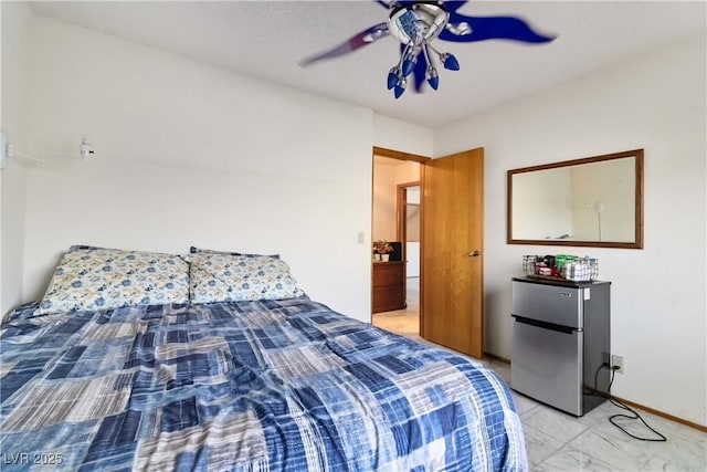 9109 Anchor Cove Ct, Las Vegas, NV 89117 - bedroom with freestanding refrigerator, light marble finish flooring, and a ceiling fan