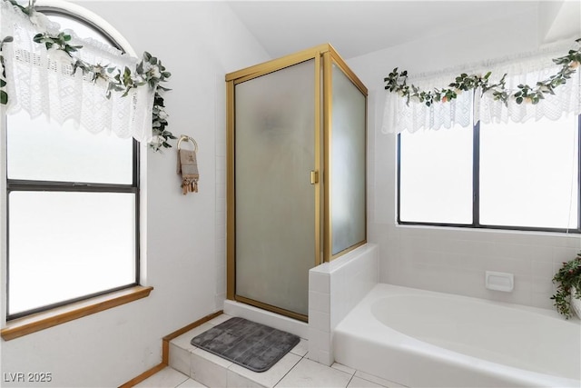 9109 Anchor Cove Ct, Las Vegas, NV 89117 - bathroom featuring plenty of natural light, a stall shower, a garden tub, and tile patterned flooring