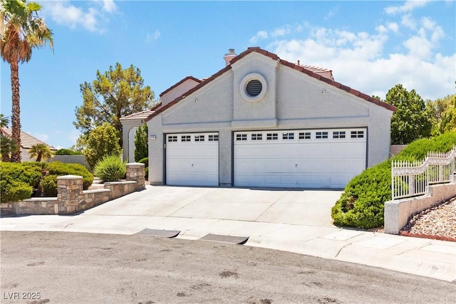 9109 Anchor Cove Ct, Las Vegas, NV 89117 - view of front facade featuring concrete driveway, a garage, stucco siding, and a tile roof