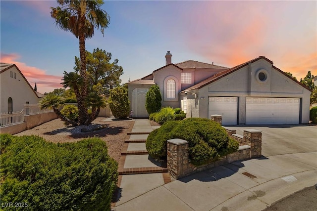 9109 Anchor Cove Ct, Las Vegas, NV 89117 - view of front of home with stucco siding, a garage, driveway, and a chimney