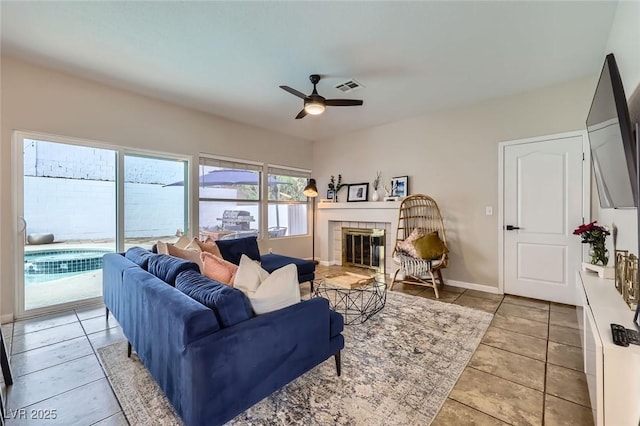 2535 Cortina Ave, Henderson, NV 89074 - living area with a ceiling fan, light tile patterned floors, and a fireplace