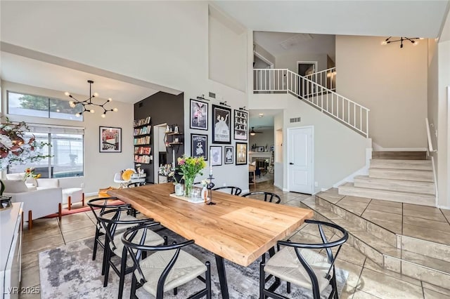 2535 Cortina Ave, Henderson, NV 89074 - dining room with a towering ceiling, stairs, and a chandelier