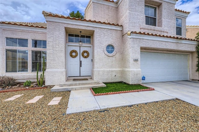 2535 Cortina Ave, Henderson, NV 89074 - view of front of property with a tiled roof, an attached garage, concrete driveway, and stucco siding