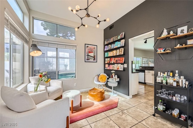 2535 Cortina Ave, Henderson, NV 89074 - living room featuring light tile patterned floors, a chandelier, and a high ceiling