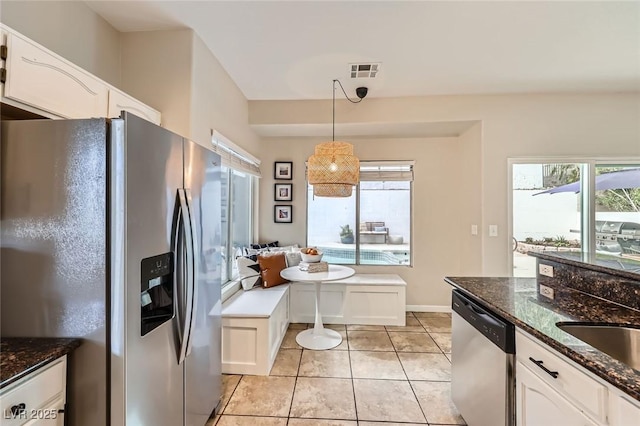 2535 Cortina Ave, Henderson, NV 89074 - kitchen featuring stainless steel appliances, white cabinets, and decorative light fixtures