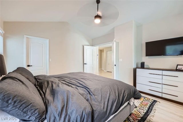 2535 Cortina Ave, Henderson, NV 89074 - bedroom with vaulted ceiling, light wood-style flooring, and a ceiling fan