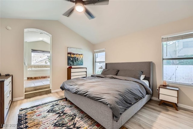2535 Cortina Ave, Henderson, NV 89074 - bedroom featuring light wood-type flooring, vaulted ceiling, ceiling fan, and connected bathroom