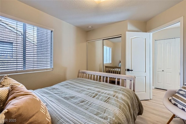2535 Cortina Ave, Henderson, NV 89074 - bedroom with light wood-style floors and a textured ceiling