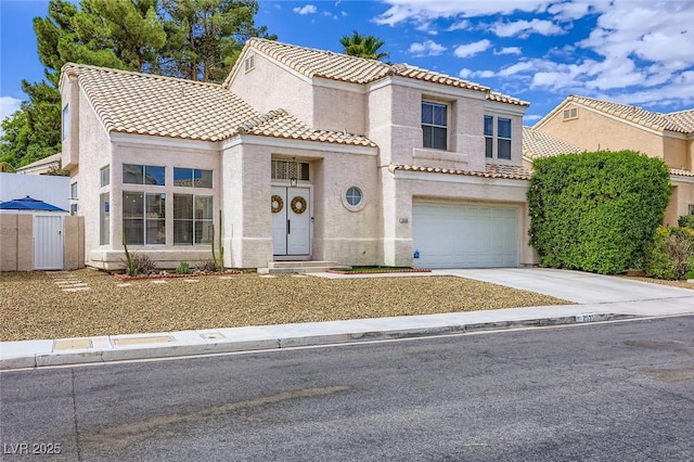 2535 Cortina Ave, Henderson, NV 89074 - mediterranean / spanish house with a tiled roof, stucco siding, concrete driveway, and an attached garage