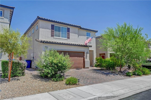 6322 Highledge St, North Las Vegas, NV 89081 - mediterranean / spanish home with stucco siding, a tiled roof, an attached garage, and decorative driveway