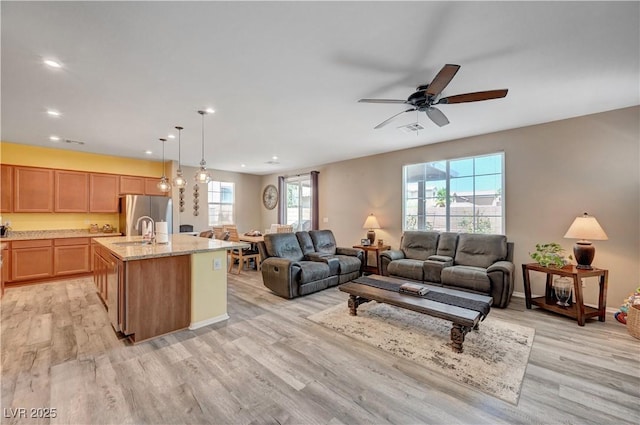 6322 Highledge St, North Las Vegas, NV 89081 - living room featuring light wood-type flooring, a ceiling fan, and recessed lighting