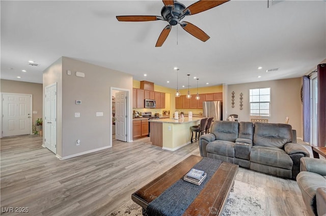 6322 Highledge St, North Las Vegas, NV 89081 - living room featuring light wood-style flooring, ceiling fan, and recessed lighting
