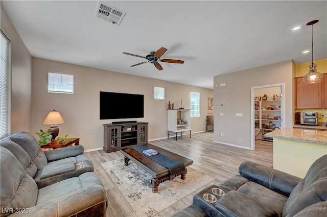 6322 Highledge St, North Las Vegas, NV 89081 - living area with light wood-type flooring, a ceiling fan, and recessed lighting