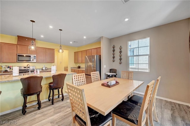 6322 Highledge St, North Las Vegas, NV 89081 - dining area with light wood-style flooring and recessed lighting